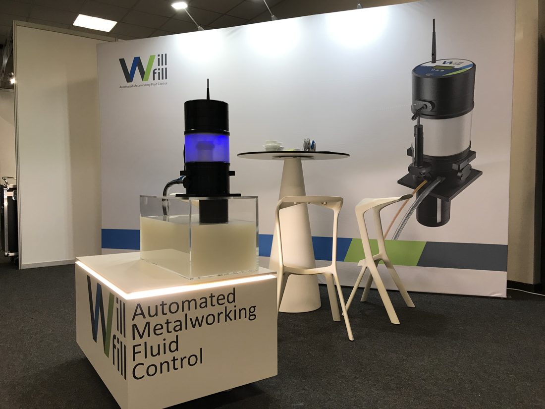 Will-Fill demo stand at a trade show, showing the automated metalworking fluid control unit on display