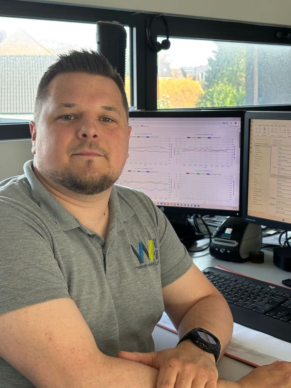 Will-Fill team member at his desk, reviewing coolant monitoring dashboards